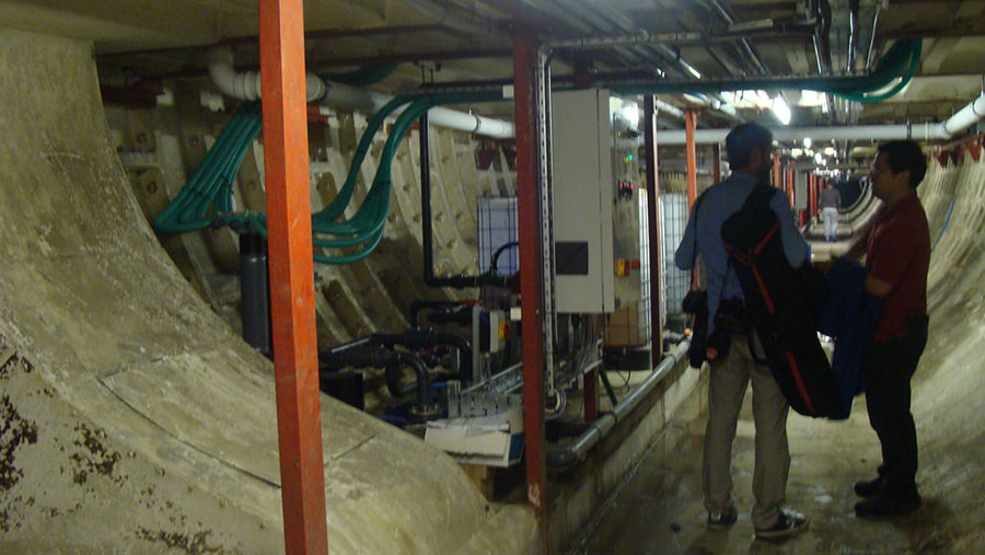 Two men talk in the converted bomb shelter which now serves as a growing space