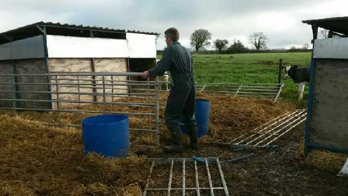 Justin Birch makes repairs to a calf hutch