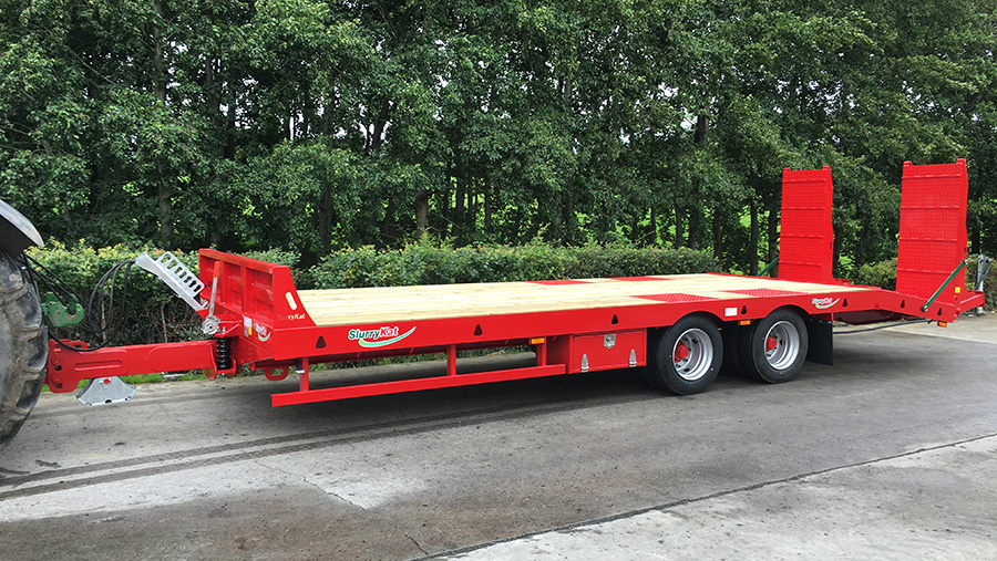 A SlurryKat trailer being towed on a road