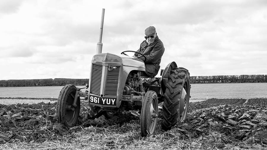 Black and white tractor ploughing