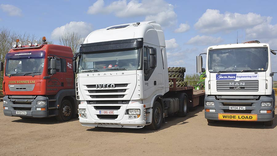 Low-loader lorries wait at a showground