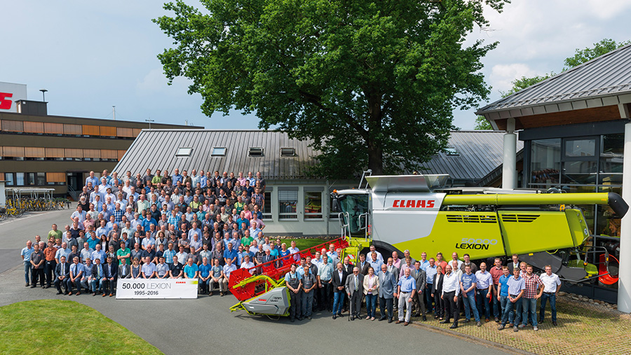 Claas staff outside with 50,000th Lexion