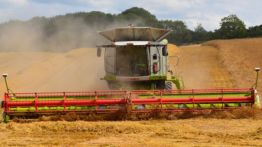 A combine works through winter barley