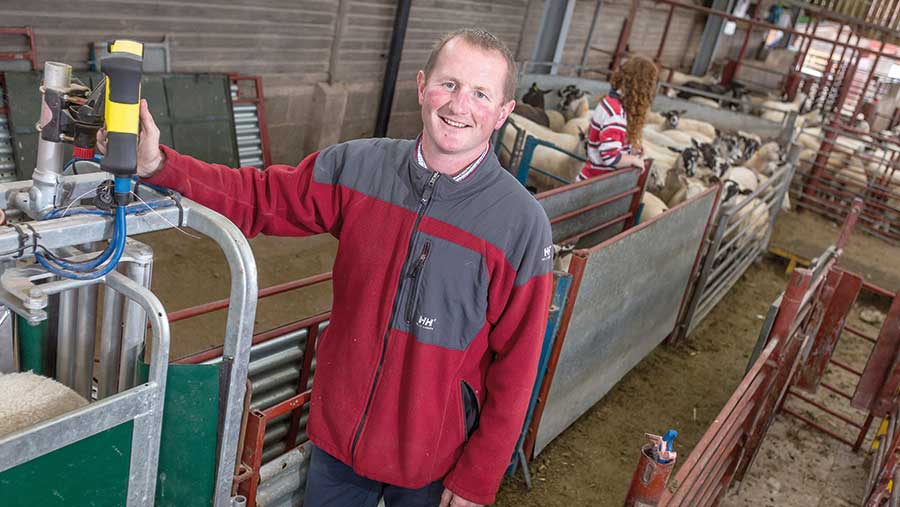 Same Jones stands in a sheep shed 