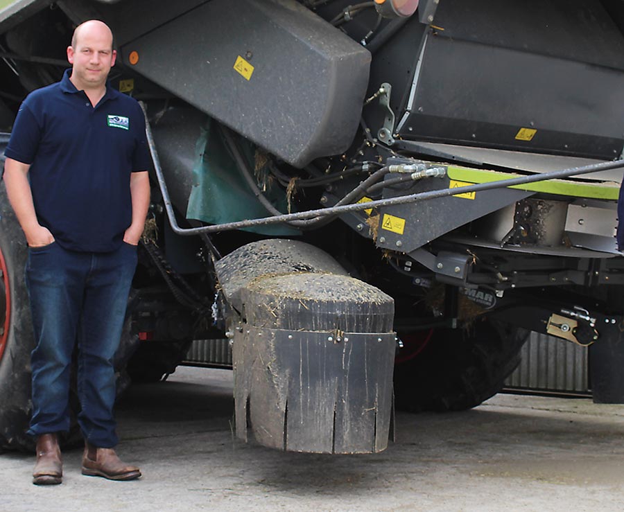 Farmer Jeremy Durrant stands beside his combine