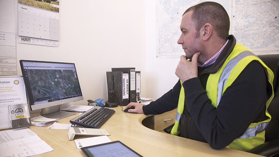 Magnus Sinclair works on a computer in his office