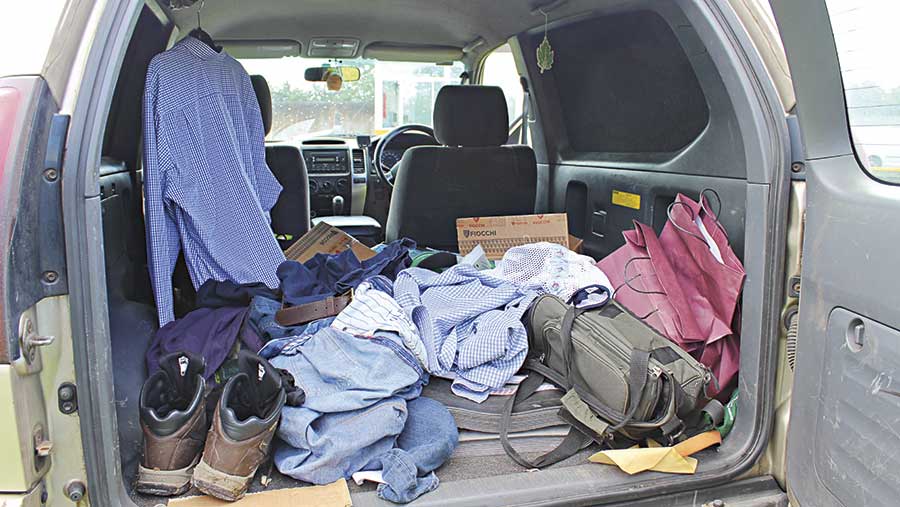 The inside of the Land Cruiser is filled with clothes and belongings 