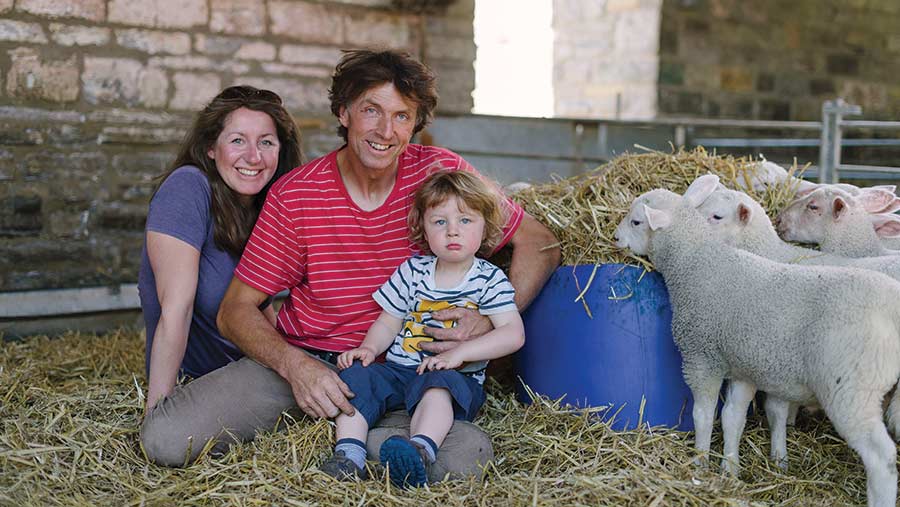 Thomas and Helen Garland with their son and lambs