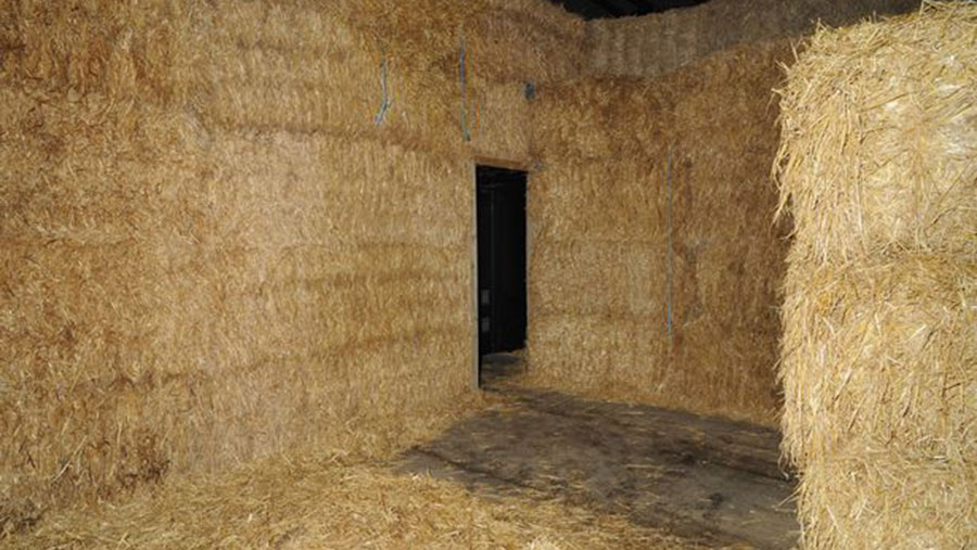 Moved straw bales reveal the entrance to a cannabis factory 