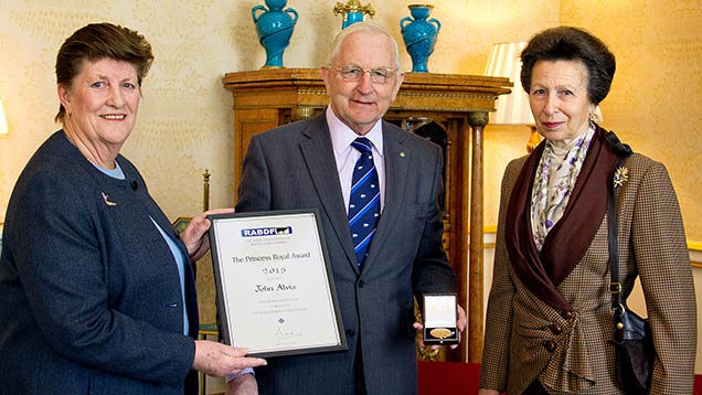 John Alvis, with his wife Pauline, receiving his award from Princess Anne.