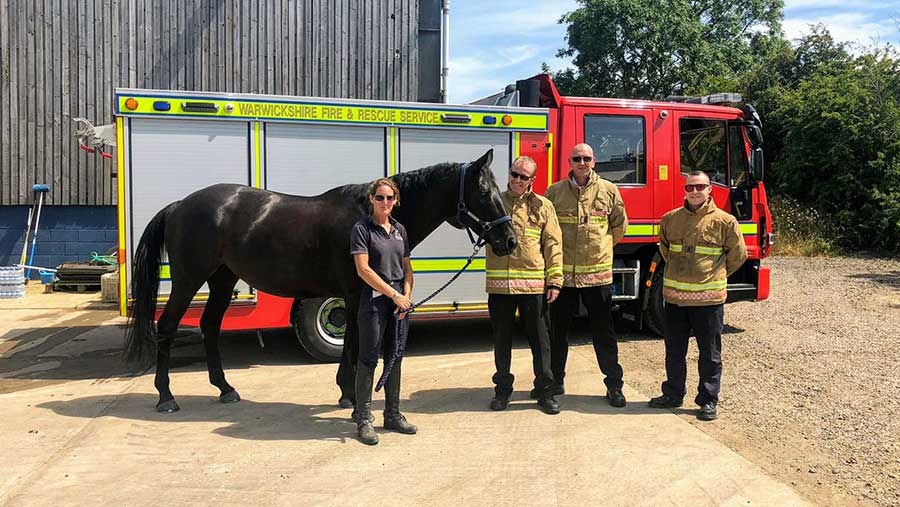 Farmer Chris Gardner’s wife Maddy, with one of their horses, and firefighters from Wellesbourne fire station