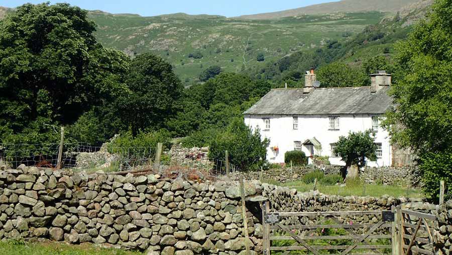 Farmhouse behind a dry stone wall