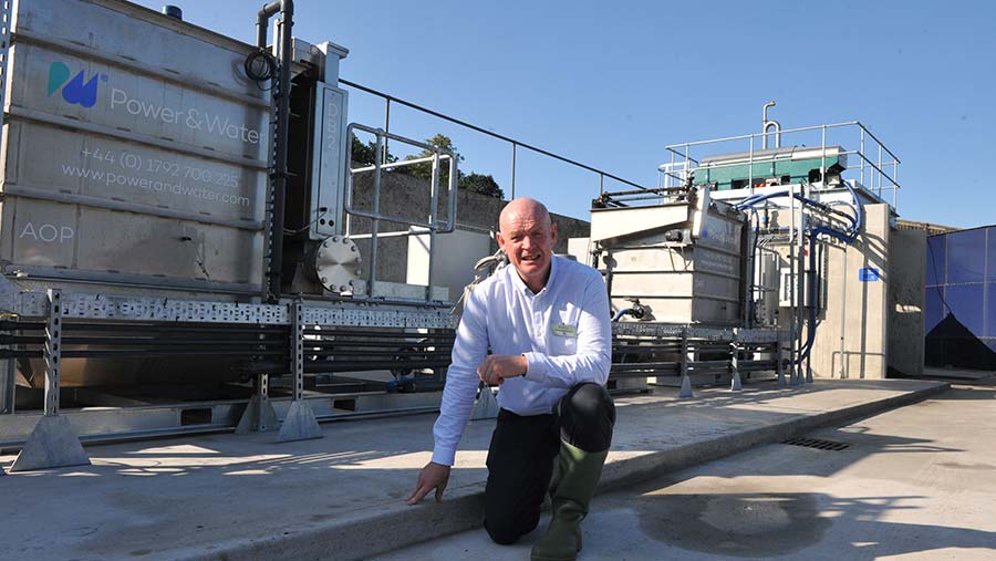 John Owen in front of the slurry purification system