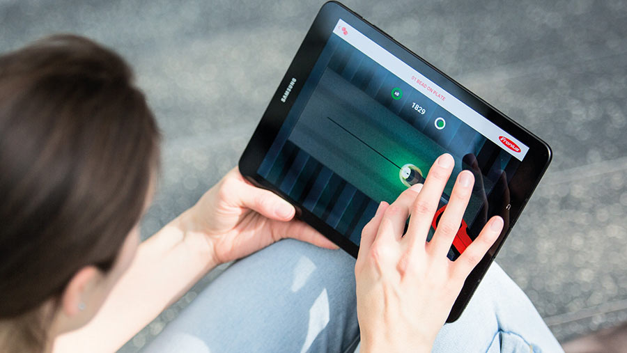 A woman using a game on a tablet