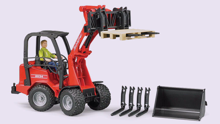 A realistic Bruder Schaffer telehandler toy with driver and various attachments