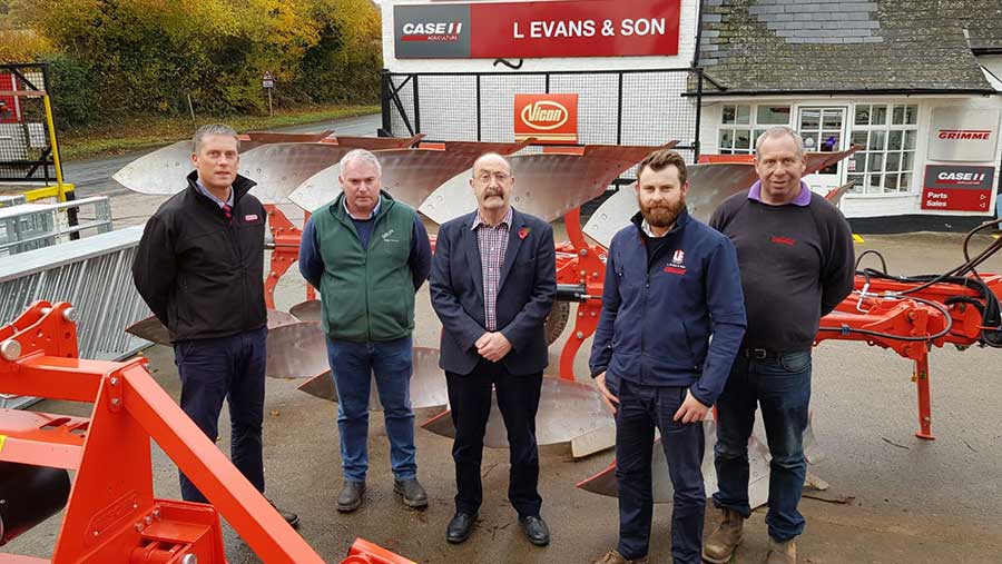 The L Evans team standing in their yard