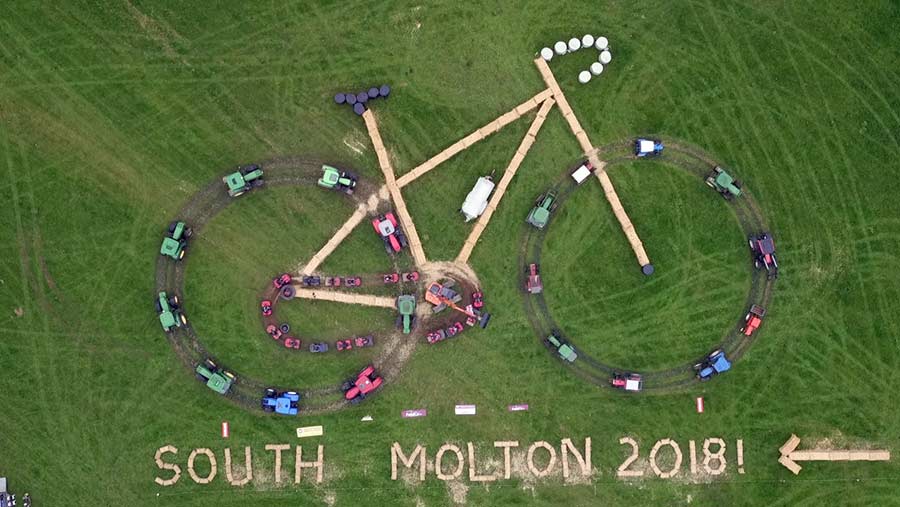 Aerial view of huge bicycle formed of farm machinery