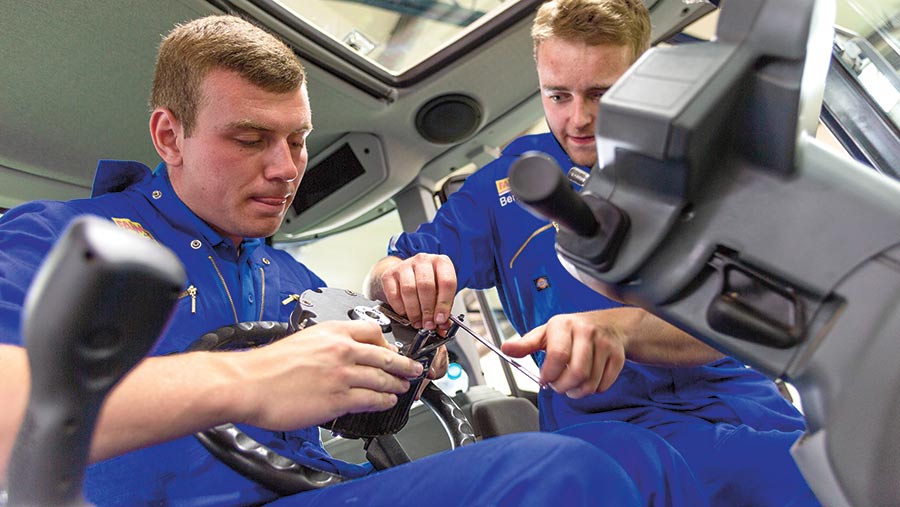 Sam Coote works on a tractor steering wheel