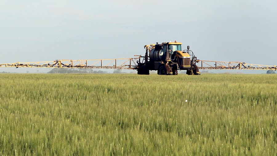 Self-propelled sprayer on a Canadian field