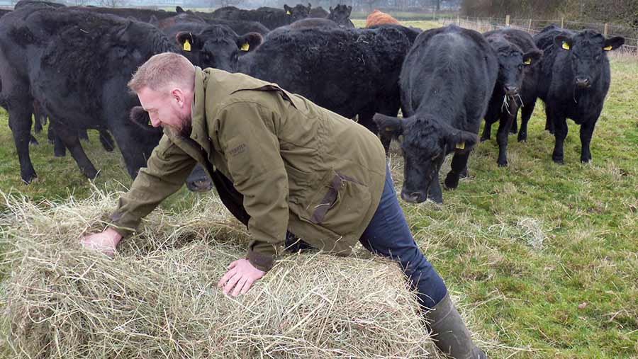 Rob Havard rolls out a round bale