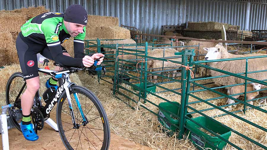 Adam Madge cycling in lambing shed © Oli Hill/RBI