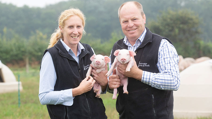 and Helen Mutimer holding piglets