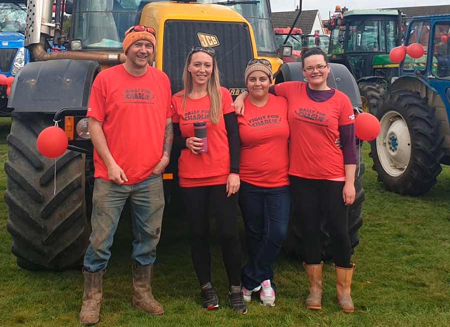 Organisers of the tractor run stand in front of a tractor