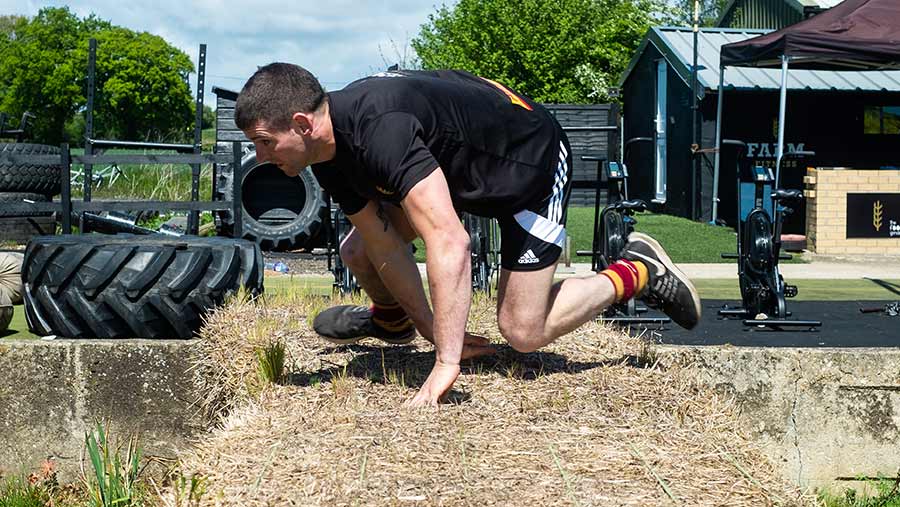 Michael Osborne leaps over a straw bale at the 2019 Britain's Fittest Farmer final