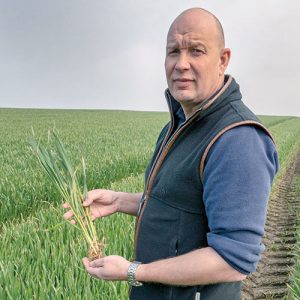 Andrew Robinson in a field of Extase wheat