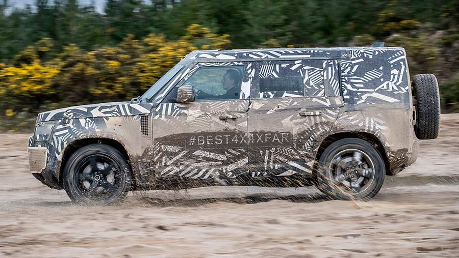 A Land Rover driving through mud