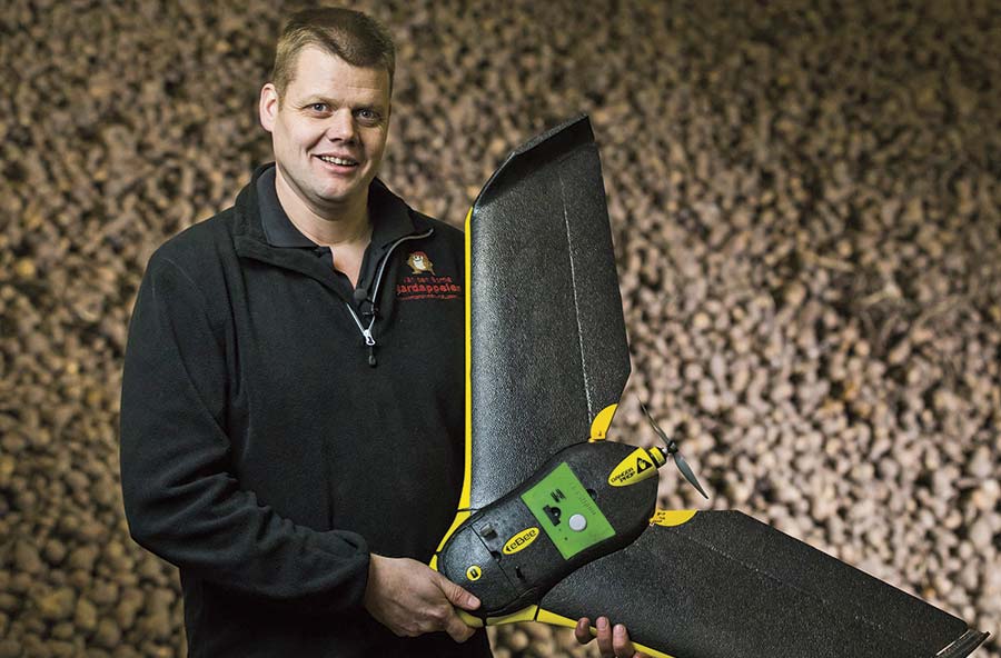 Dutch farmer Jacob Van den Borne holds a drone aircraft