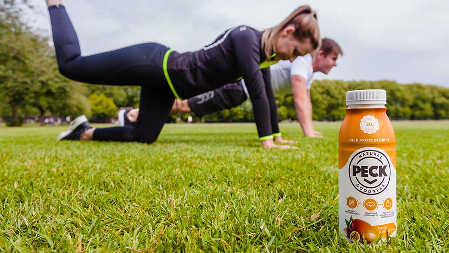 Fitness couple with Peck drink