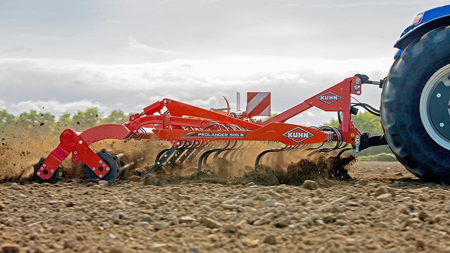 A tractor pulling a cultivator