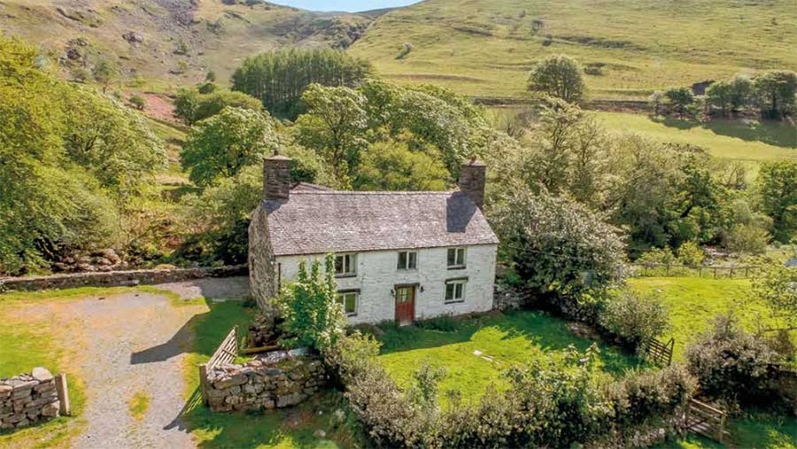 A farmhouse by some hills