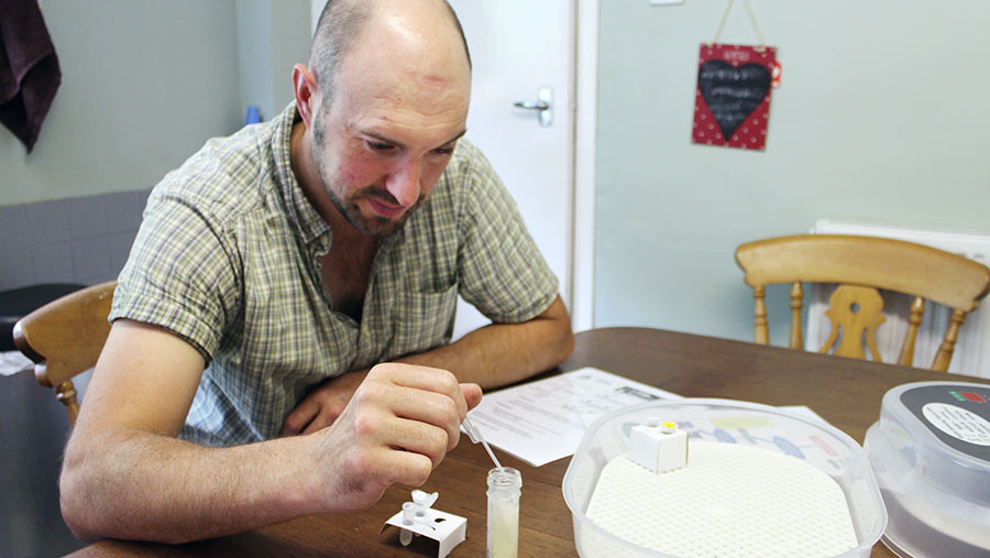 Man using a pipette with a test tube