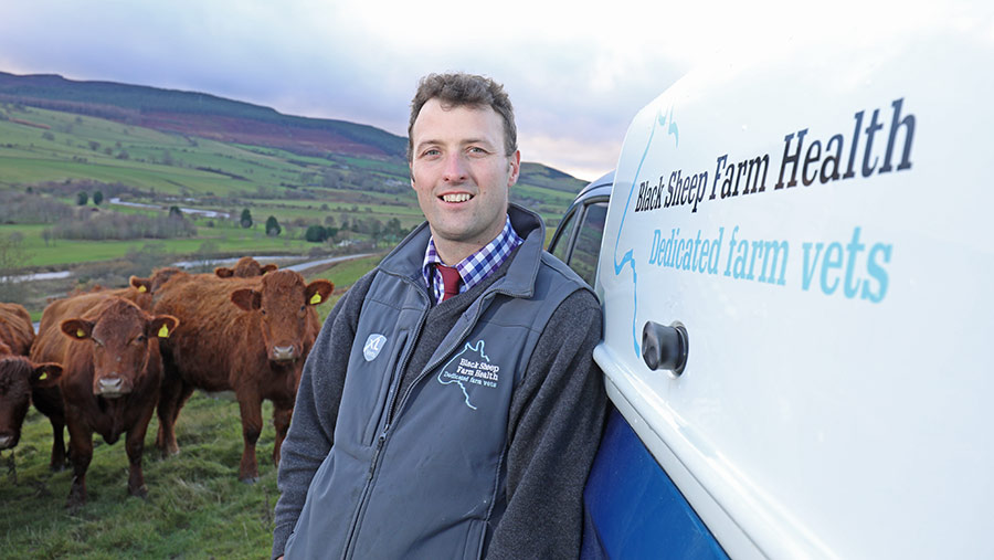 Vet Joe Henry beside his van on a farm