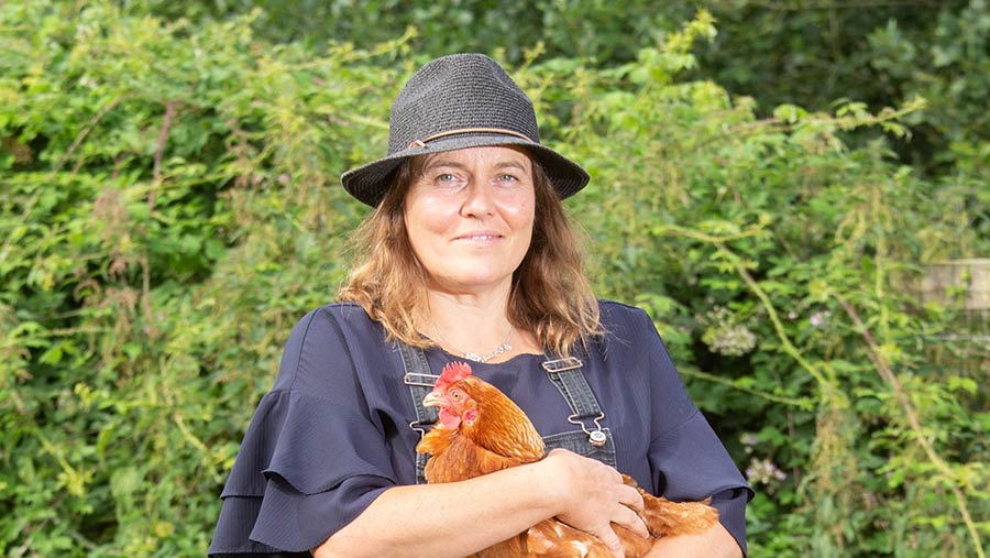 Susie Macmillan holding a chicken