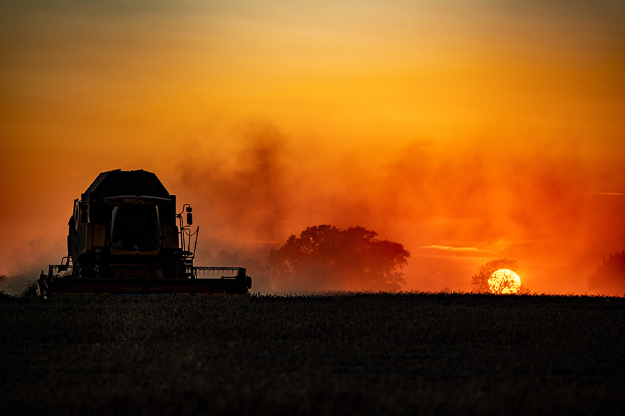 Combine sunset silhouette by Sue Cross