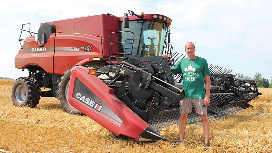 Jim Denys in field with machinery