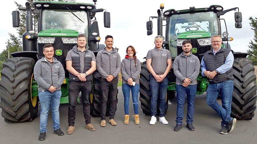 Bridgestone team in front of tractors