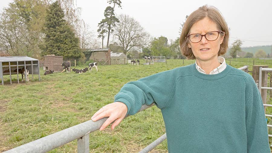 Elizabeth Birkett standing by a fence in a field