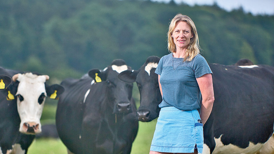 Becci Berry in a field with dairy cows