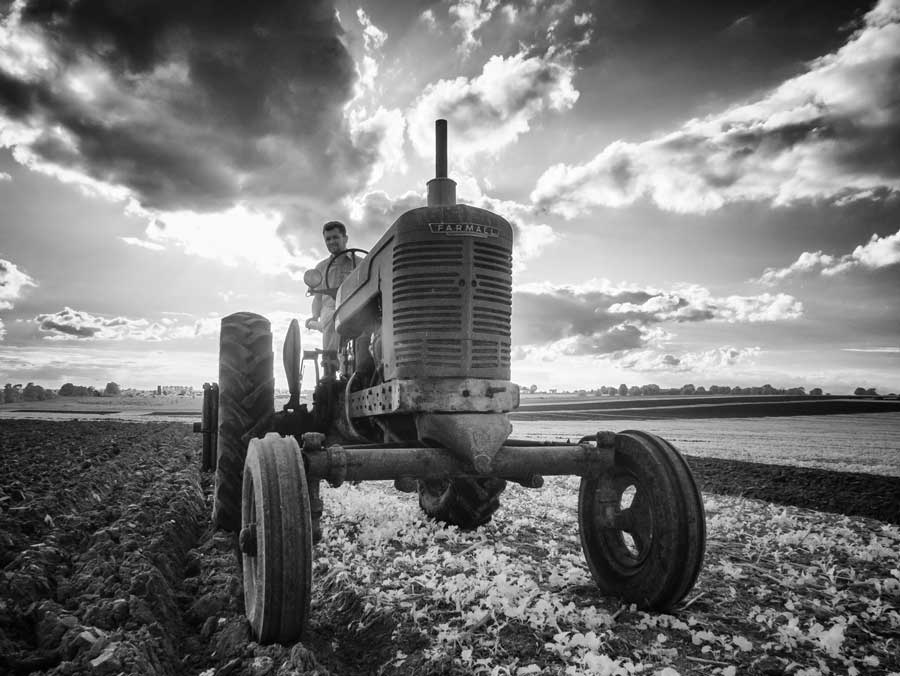 Black and white 1940s tractor in field