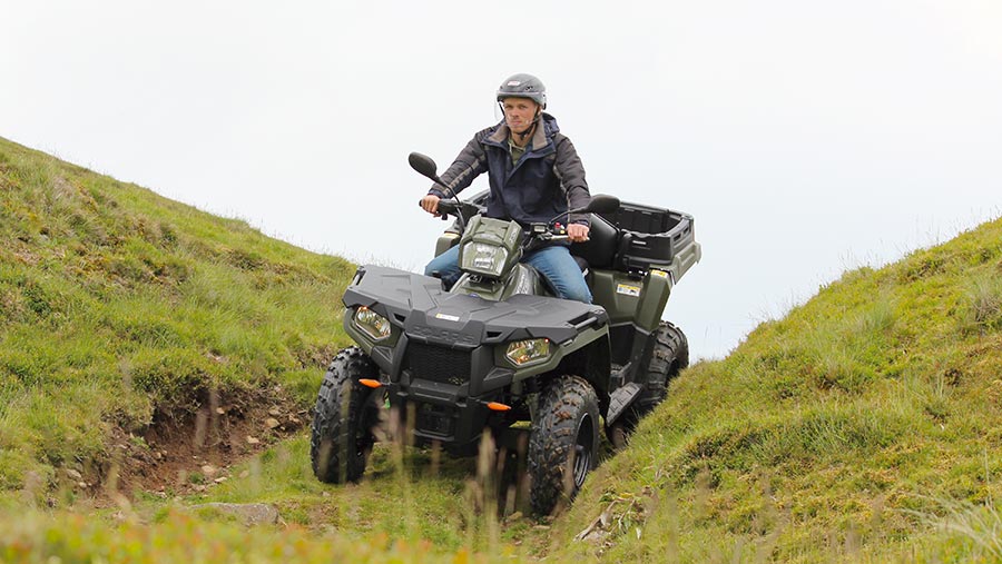 Man riding ATV in field