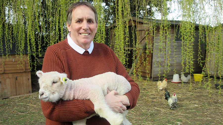 Man holding lamb in his arms