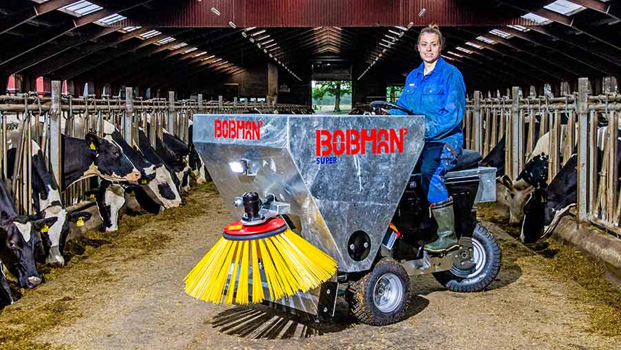 GIrl on ride-on Bobman Super in cow shed