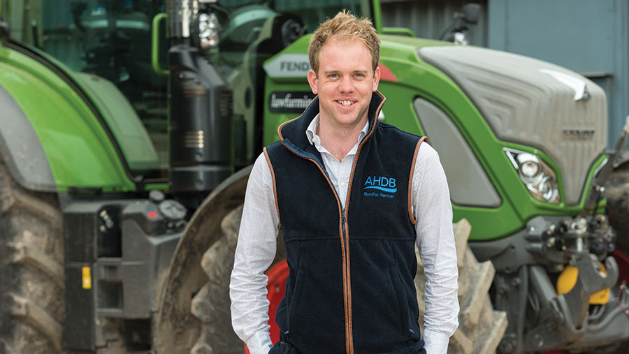 David Hurst standing in front of a tractor