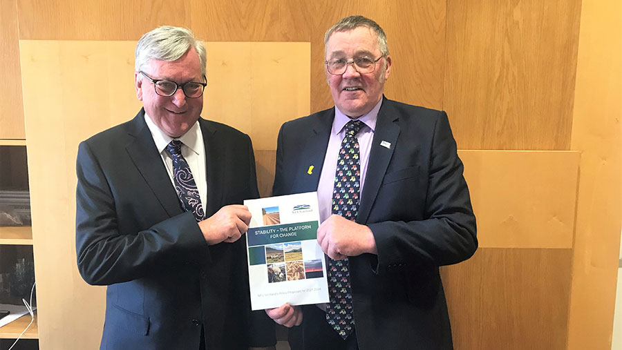 Andrew McCornick  (right) hands over the NFUS policy document to Fergus Ewing