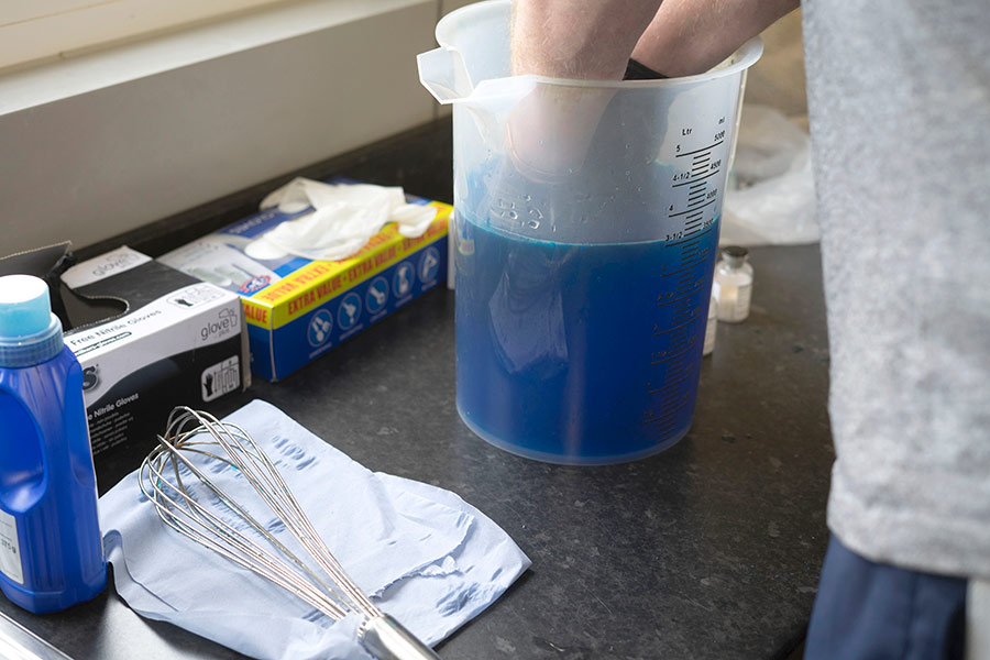 Blue liquid in jug on counter