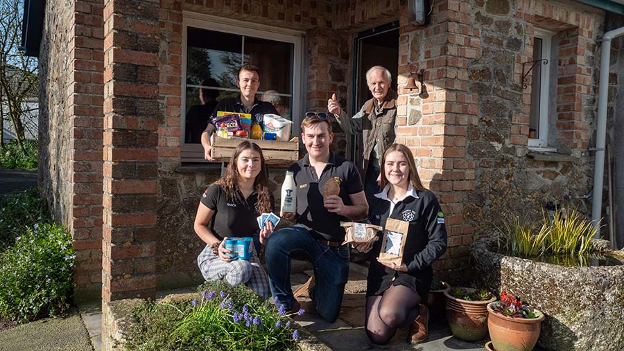 Member of YFC with shopping outside house